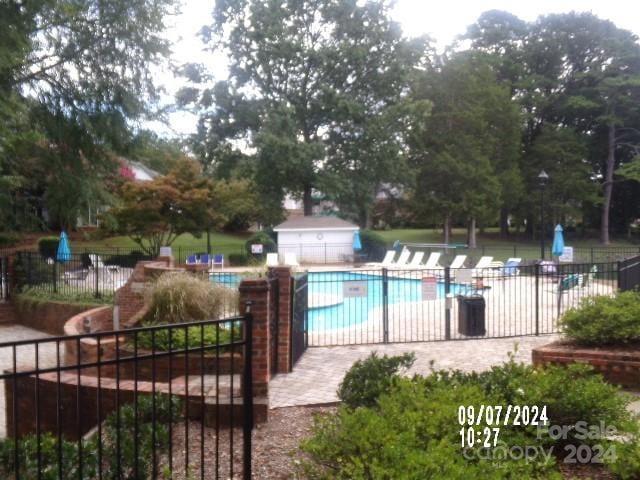 view of swimming pool featuring a patio area