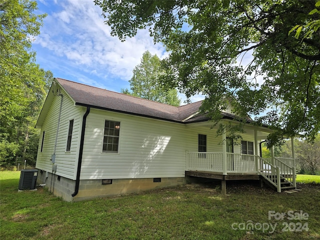 back of property featuring a yard and central AC unit