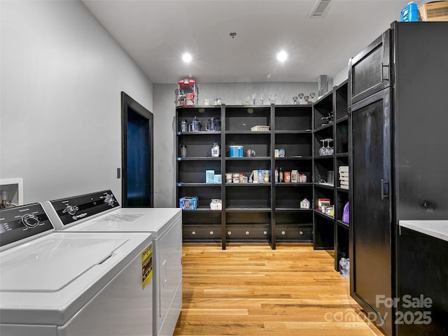 laundry area featuring light wood finished floors, recessed lighting, visible vents, washing machine and dryer, and laundry area