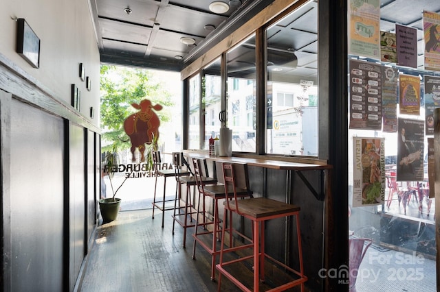 interior space featuring a dry bar and wood finished floors