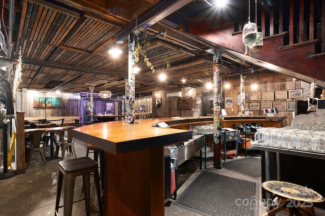 bar featuring concrete flooring and a community bar