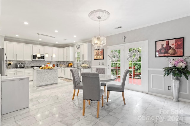 dining room featuring visible vents, wainscoting, marble finish floor, ornamental molding, and a notable chandelier
