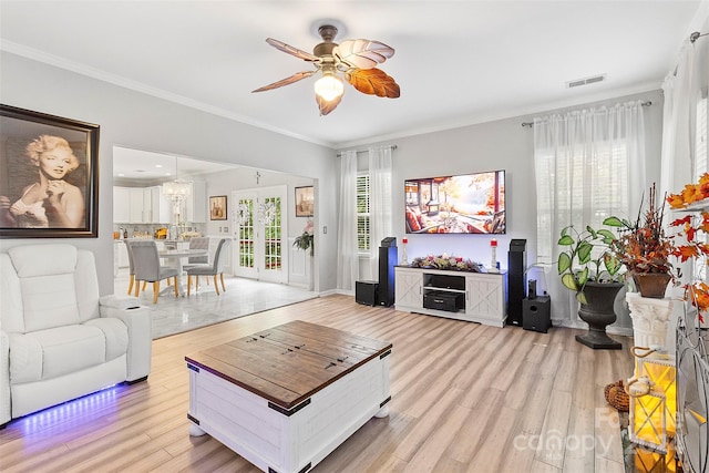 living room with ceiling fan, ornamental molding, and light hardwood / wood-style floors