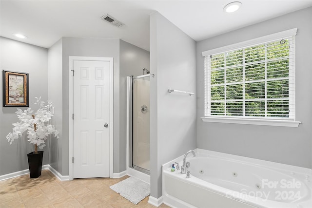 full bath featuring a stall shower, a tub with jets, visible vents, and baseboards