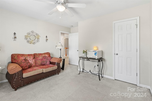 living room featuring light colored carpet and ceiling fan