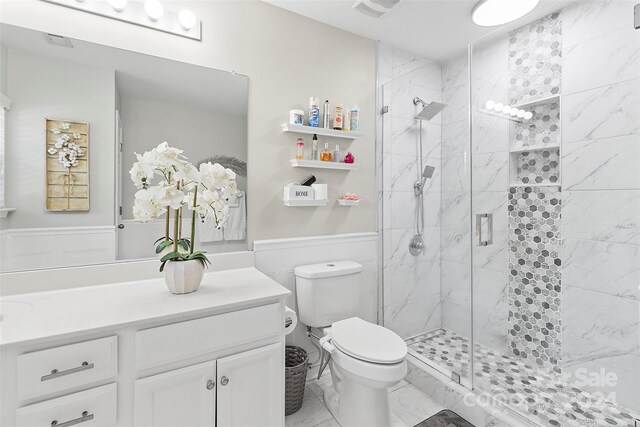 bathroom featuring a shower stall, visible vents, toilet, and vanity