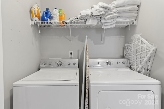 clothes washing area featuring washing machine and clothes dryer