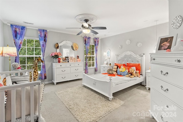 bedroom with visible vents, baseboards, ceiling fan, ornamental molding, and light carpet