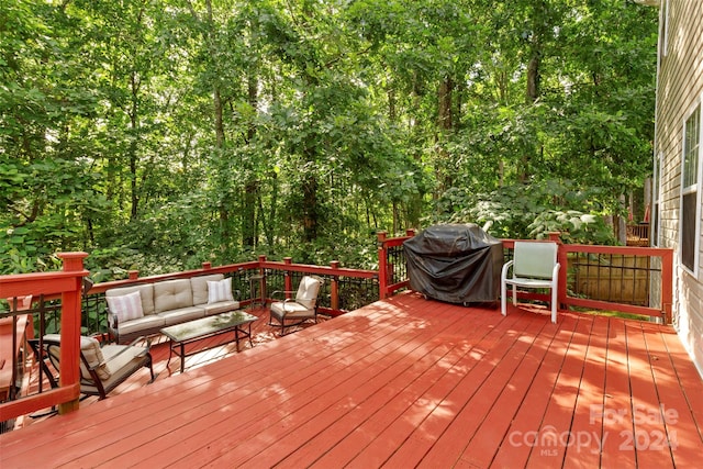 wooden deck with area for grilling and an outdoor hangout area