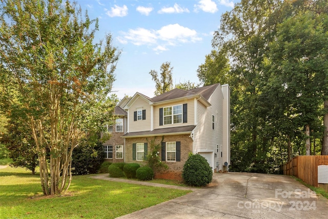 view of front of house featuring a garage and a front yard