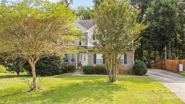 obstructed view of property featuring a front yard