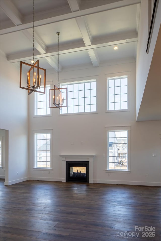 837 Lake Forest Drive Nottingham, Belmont, NC 28012 - unfurnished living room with a chandelier, a high ceiling, coffered ceiling, dark wood-style floors, and beamed ceiling