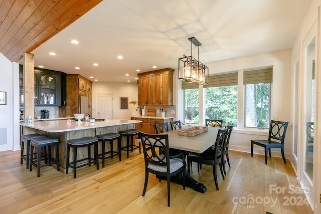 dining room featuring sink and light hardwood / wood-style flooring