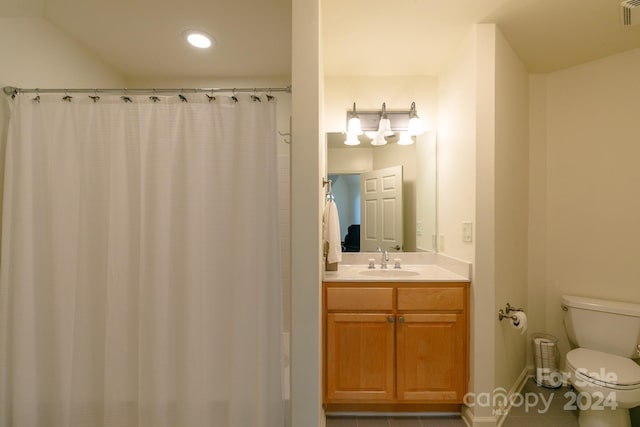 bathroom with vanity, toilet, walk in shower, and tile patterned flooring