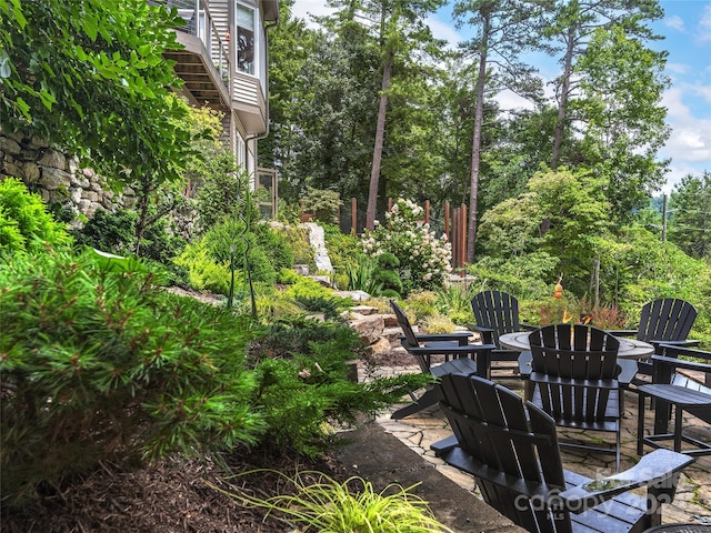 view of yard featuring a fire pit and a patio