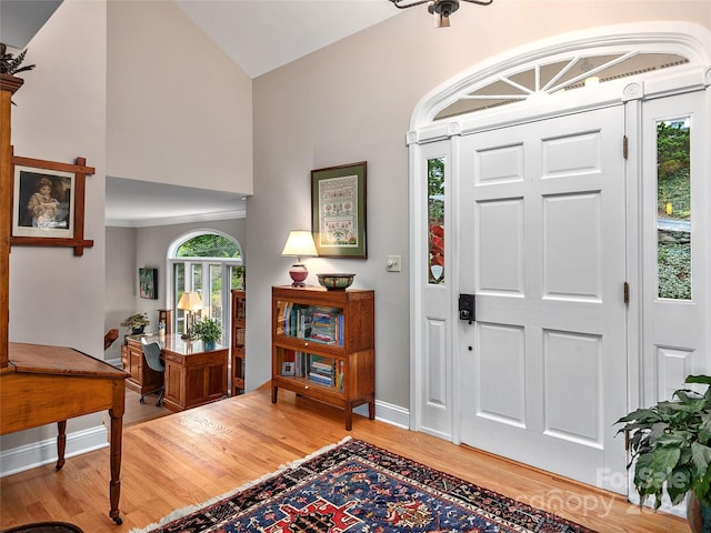 foyer featuring lofted ceiling and light hardwood / wood-style floors