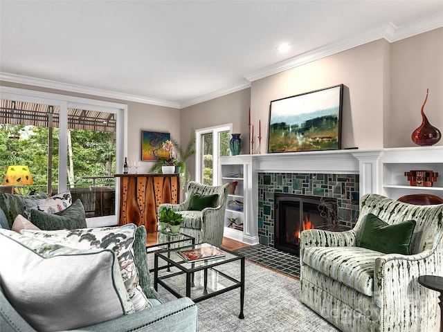 living room with a fireplace, ornamental molding, and wood-type flooring