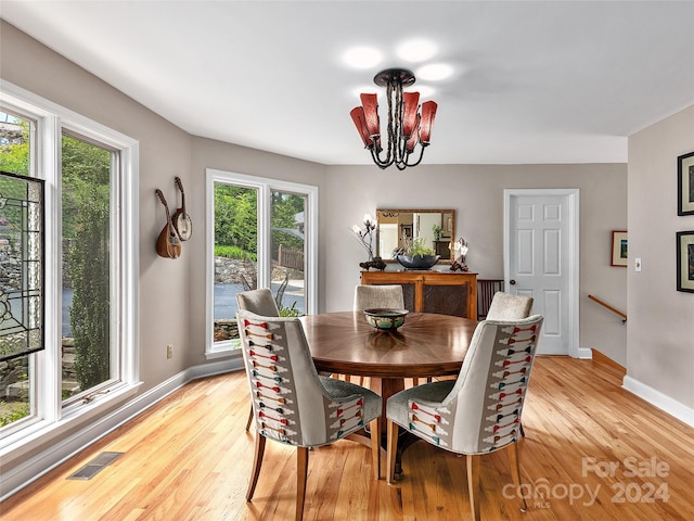 dining room featuring light hardwood / wood-style flooring and a chandelier