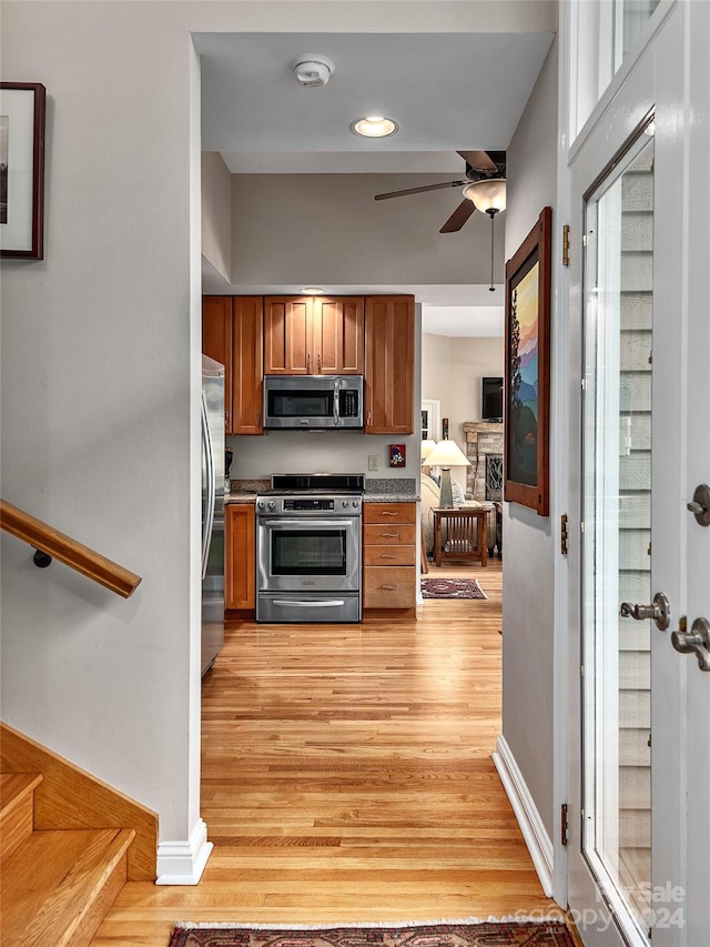 kitchen featuring light hardwood / wood-style flooring, stainless steel appliances, and ceiling fan