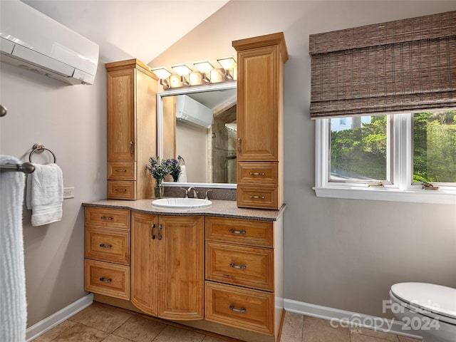 bathroom featuring vanity, toilet, tile patterned floors, and a wall mounted air conditioner