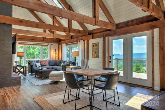 interior space featuring a wealth of natural light and vaulted ceiling with beams