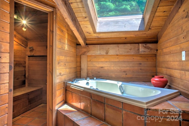 bathroom featuring wood ceiling, a tub to relax in, vaulted ceiling with skylight, and wooden walls