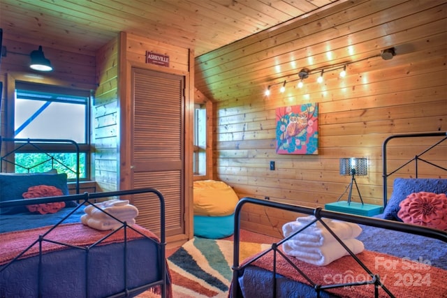 bedroom with wood ceiling, carpet, and wooden walls