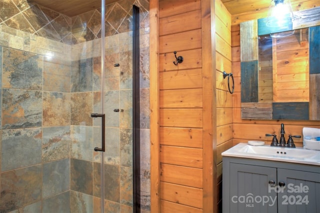 bathroom with wood ceiling, vanity, wood walls, and an enclosed shower