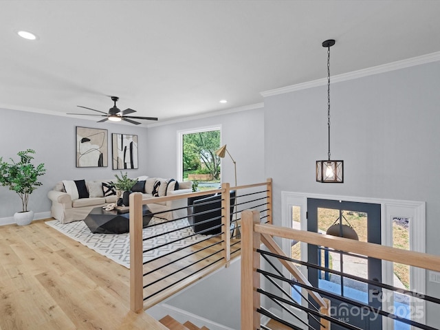 living room with ceiling fan, crown molding, and hardwood / wood-style floors