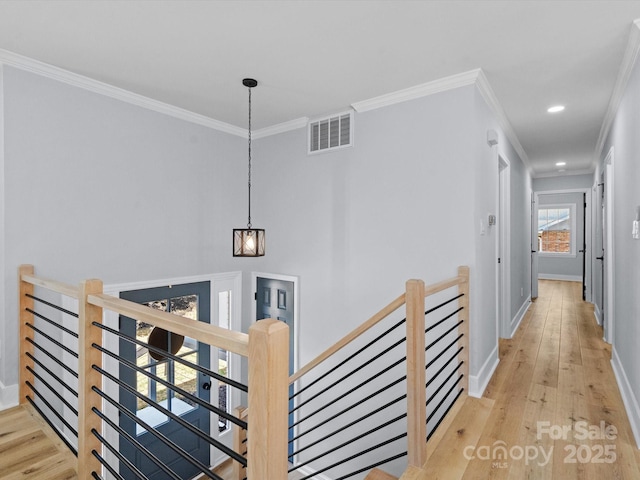 hall featuring light wood-type flooring and ornamental molding