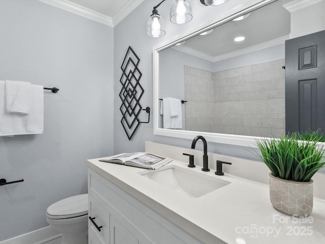 bathroom with toilet, vanity, and crown molding