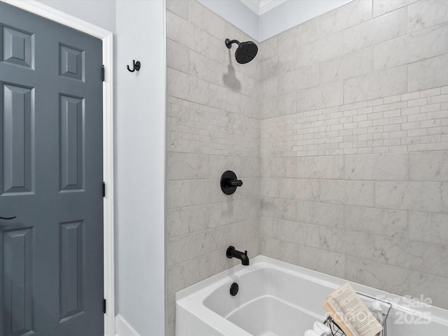 bathroom with tiled shower / bath combo and crown molding