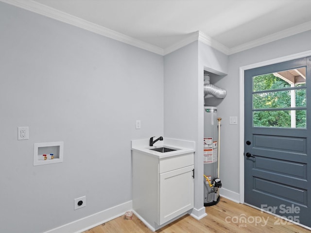 washroom with sink, crown molding, water heater, washer hookup, and hookup for an electric dryer