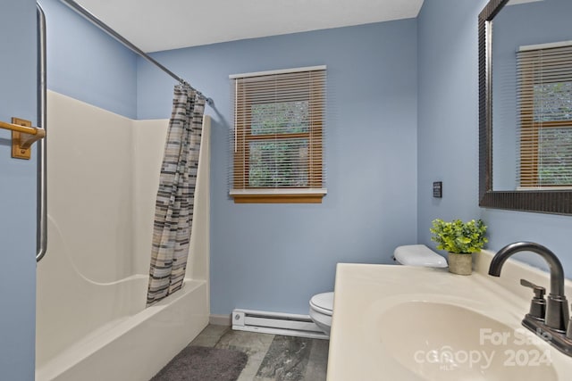 full bathroom featuring a baseboard heating unit, vanity, toilet, and a healthy amount of sunlight