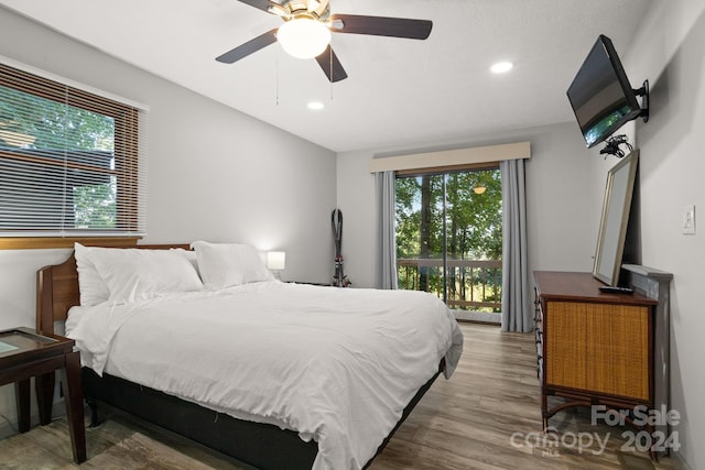 bedroom featuring wood-type flooring, access to outside, and ceiling fan