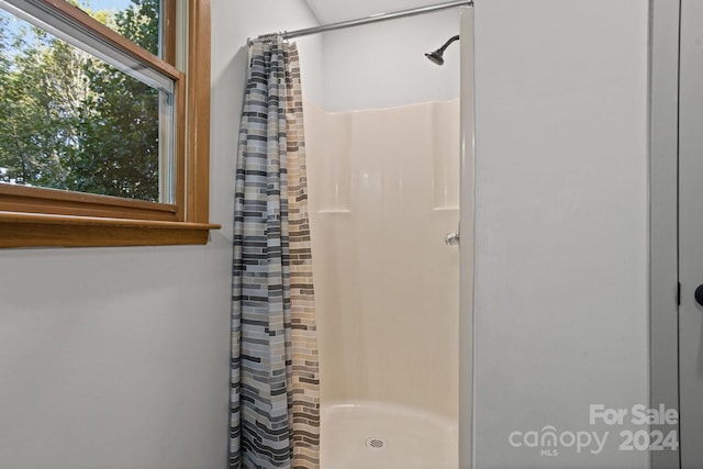 bathroom with a shower with shower curtain