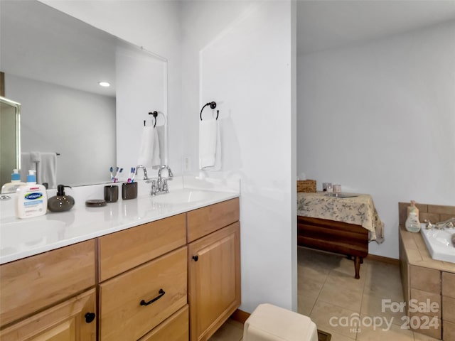 bathroom featuring vanity, tile patterned floors, and a relaxing tiled tub