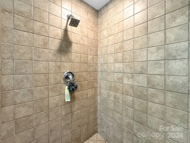 bathroom with tiled shower