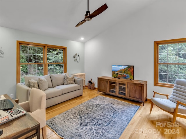 living room with light wood-type flooring, ceiling fan, and lofted ceiling