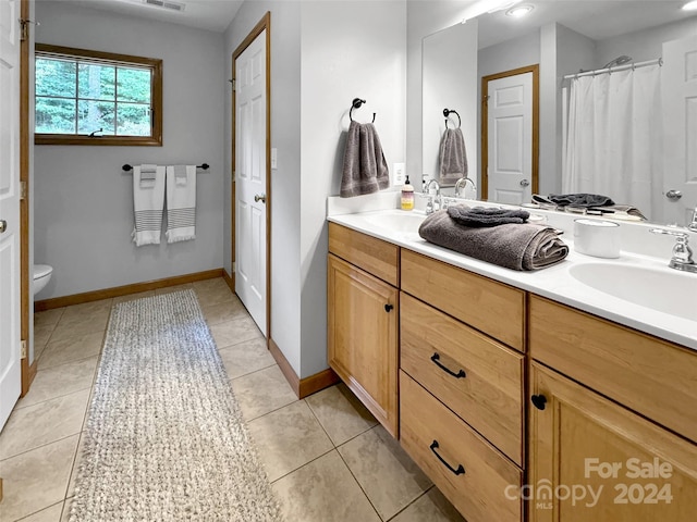 bathroom featuring vanity, toilet, and tile patterned floors