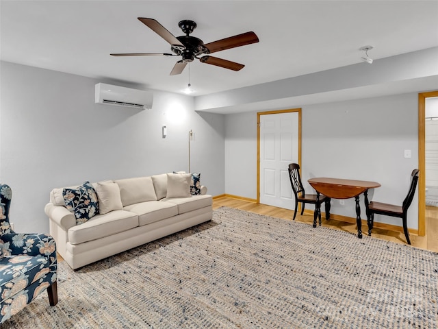 living room featuring ceiling fan, a wall mounted air conditioner, and light hardwood / wood-style floors