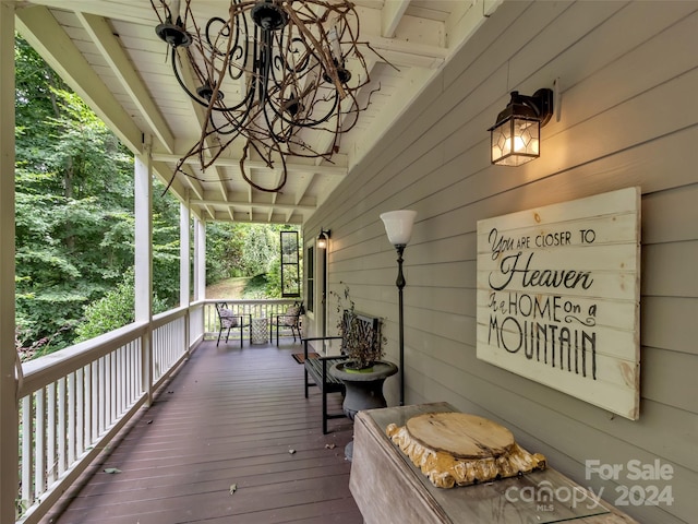 wooden terrace featuring covered porch