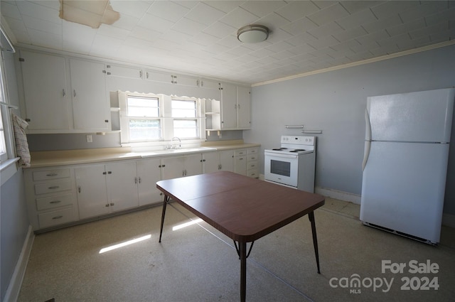 kitchen with ornamental molding, sink, white appliances, and white cabinetry