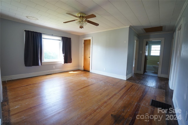 unfurnished room featuring crown molding, a wealth of natural light, hardwood / wood-style floors, and ceiling fan