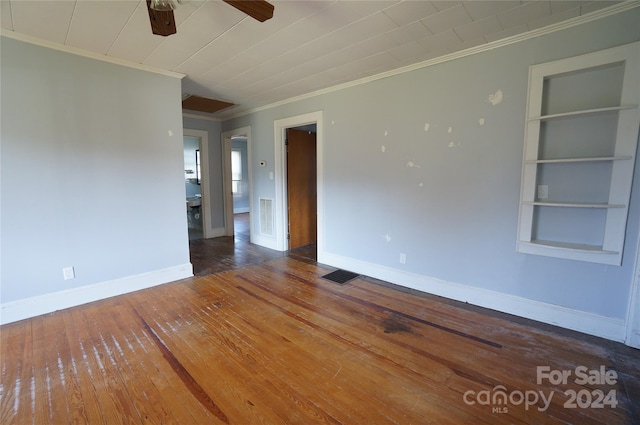 empty room with ceiling fan, crown molding, and wood-type flooring