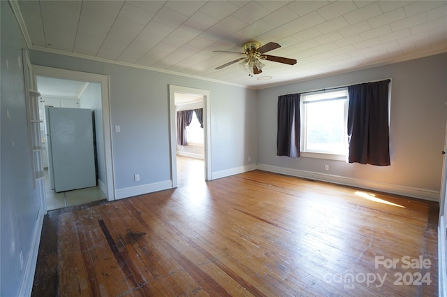 empty room with crown molding, ceiling fan, and hardwood / wood-style floors