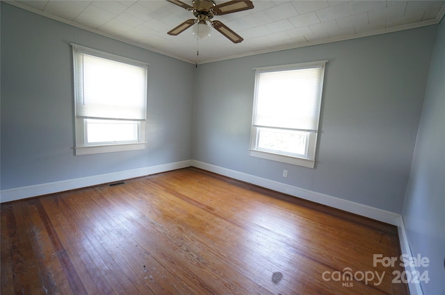 spare room featuring crown molding, ceiling fan, and hardwood / wood-style flooring