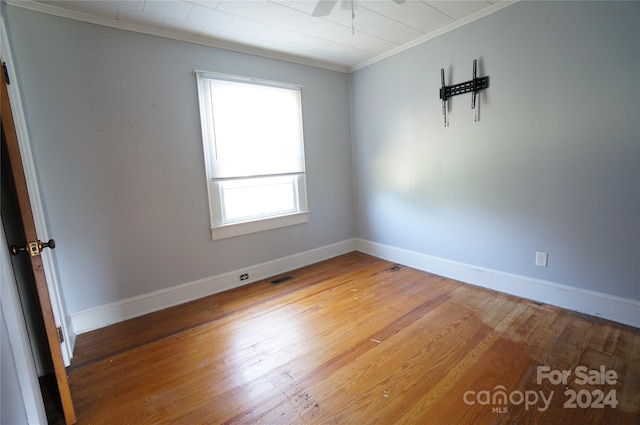 unfurnished room with crown molding, hardwood / wood-style floors, and ceiling fan