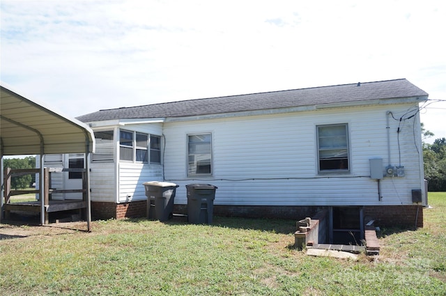 rear view of house featuring a lawn