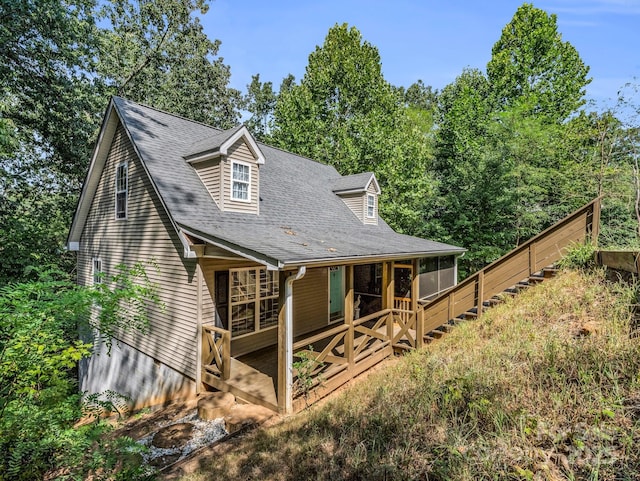 view of front of home featuring roof with shingles